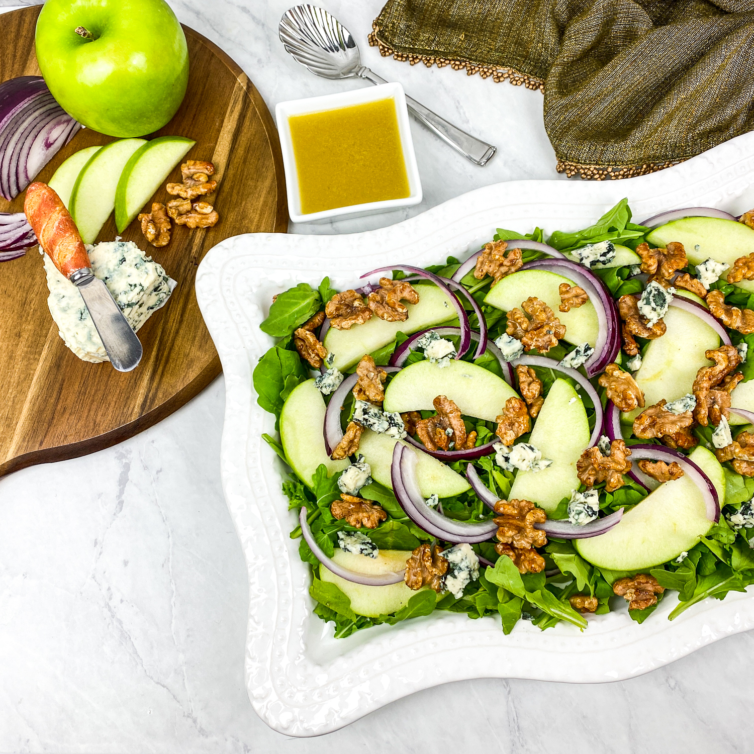 Plated apple walnut salad with dressing