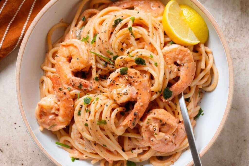 A bowl of creamy tomato shrimp pasta