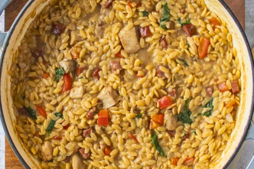 delectable Creamy Chicken And Chorizo Orzo in a pan