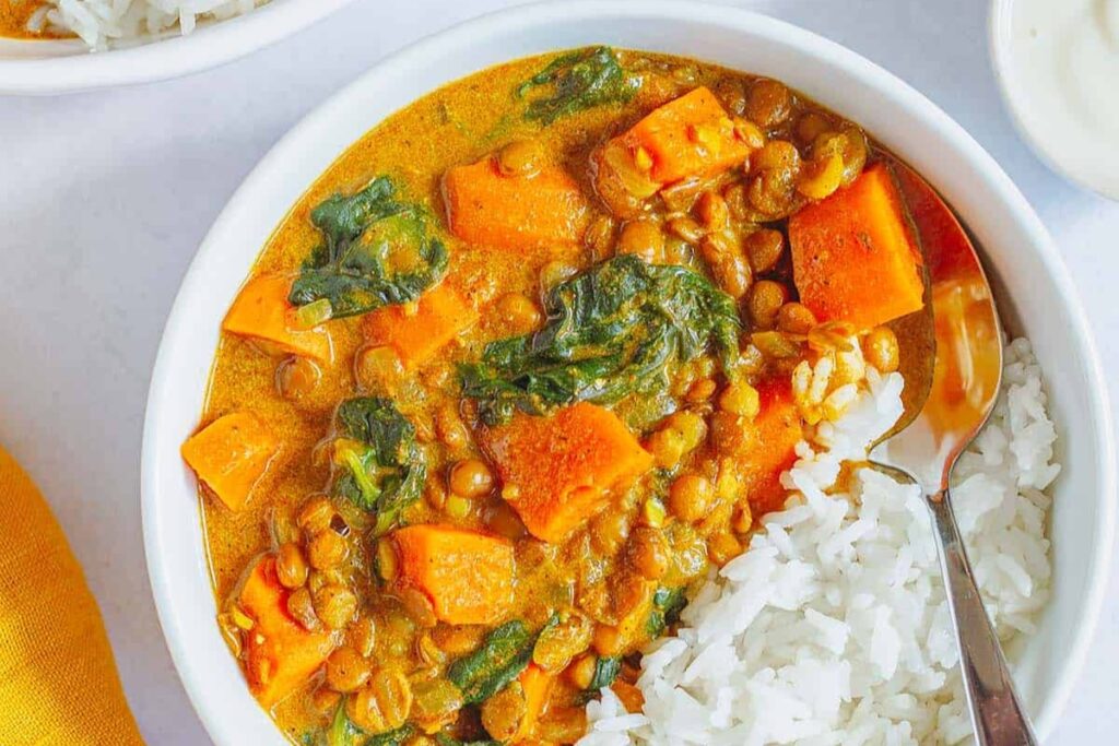 A bowl of Easy Sweet Potato And Lentil Curry With Spinach