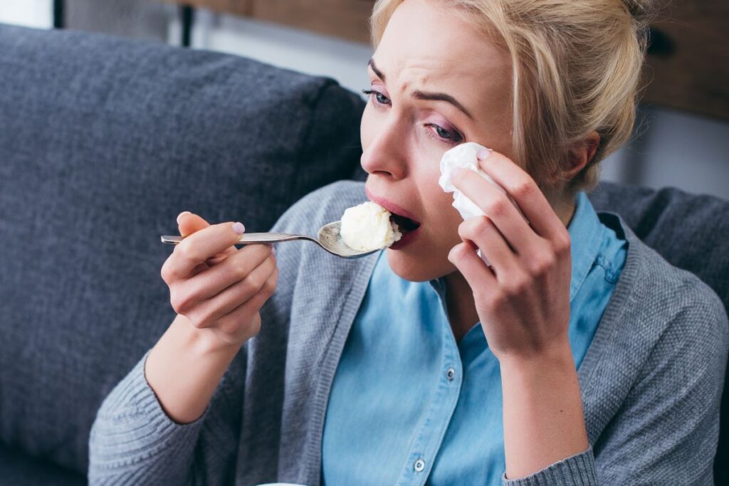 Woman crying and eating ice cream