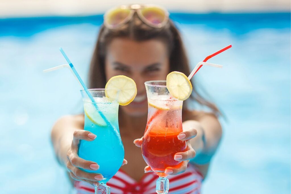 Woman holding summer drinks.