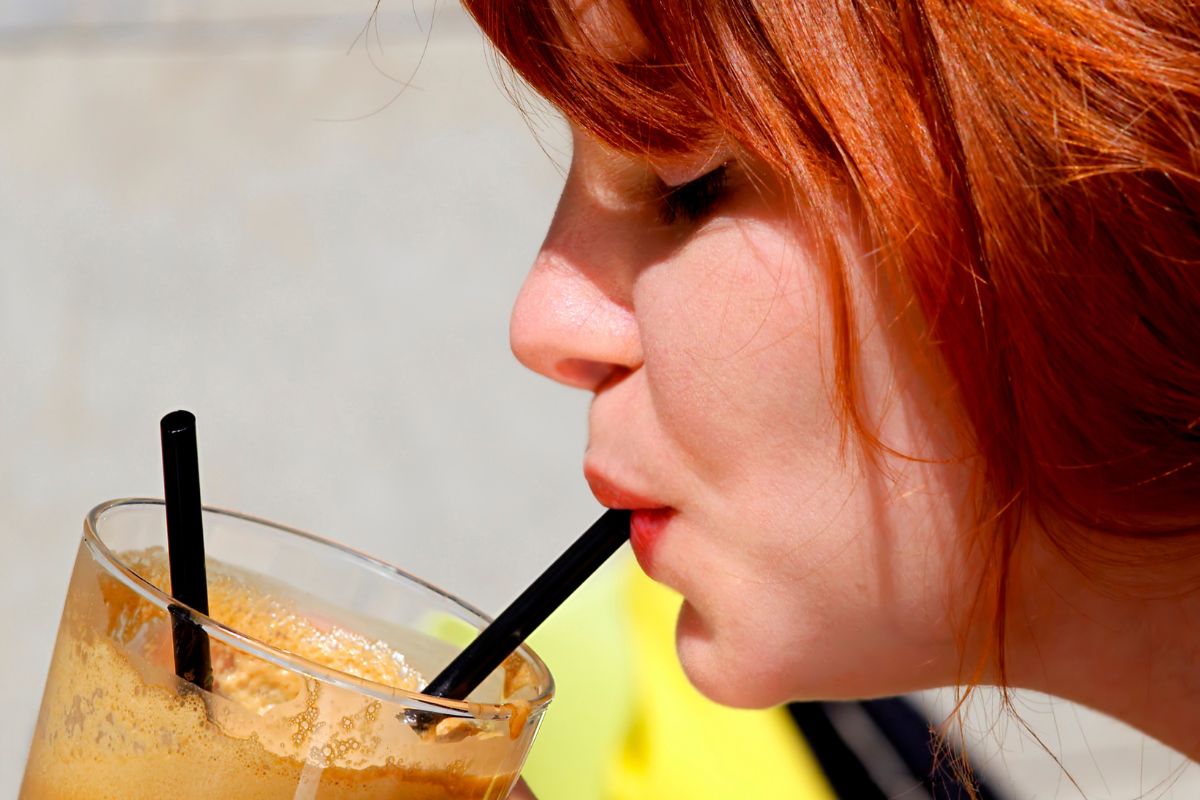 Woman sipping iced coffee