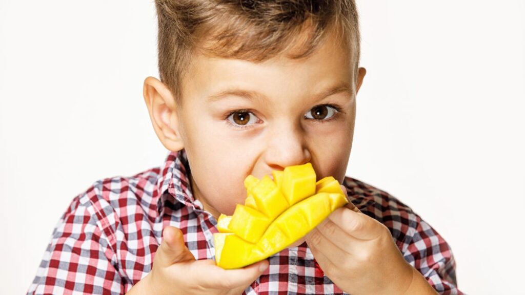 boy eating mango