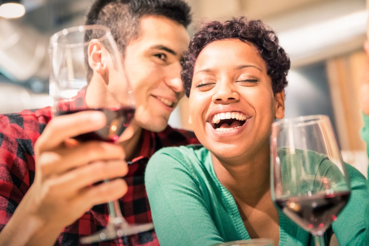 cheerful couple drinking wine in love