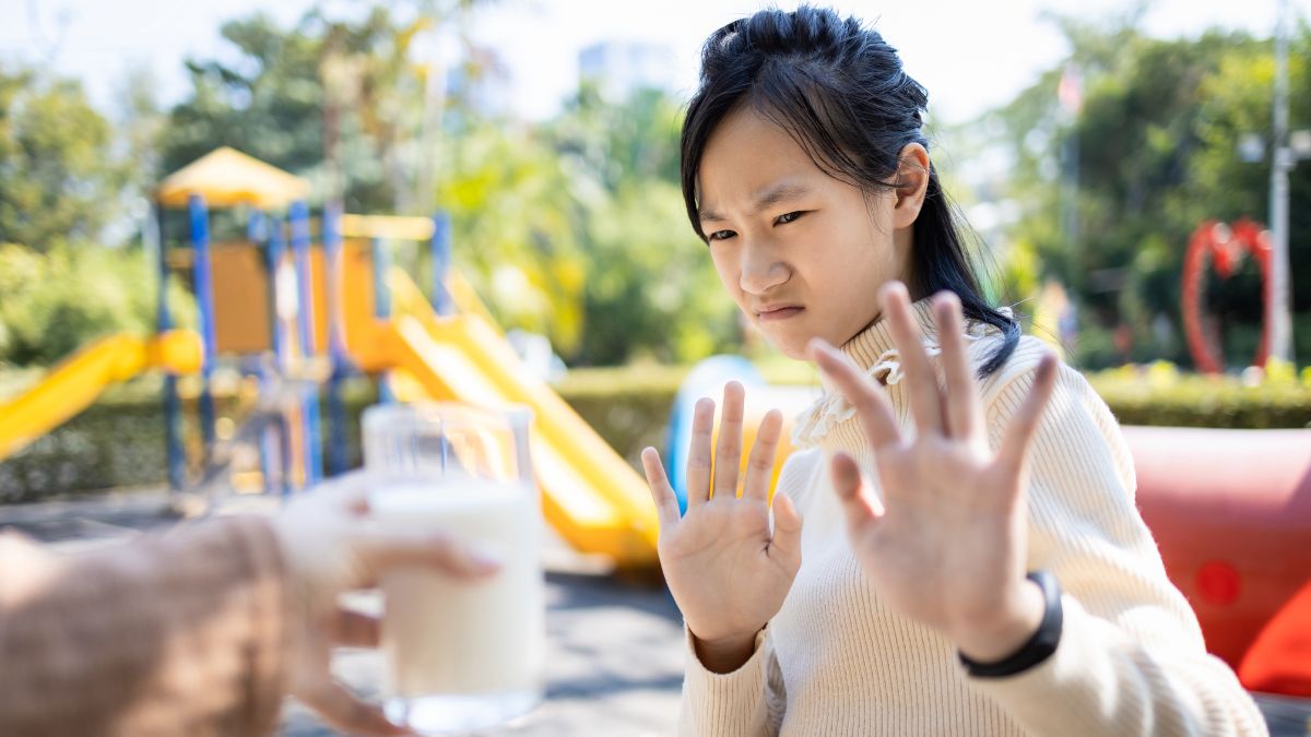 disgusted looking girl with hands up saying no to drink