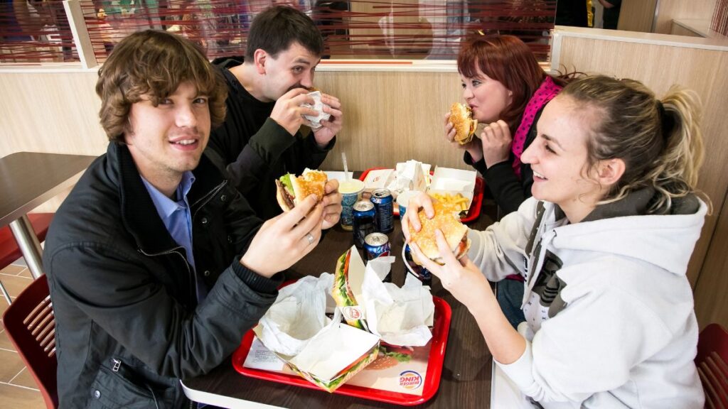 friends eating burgers out