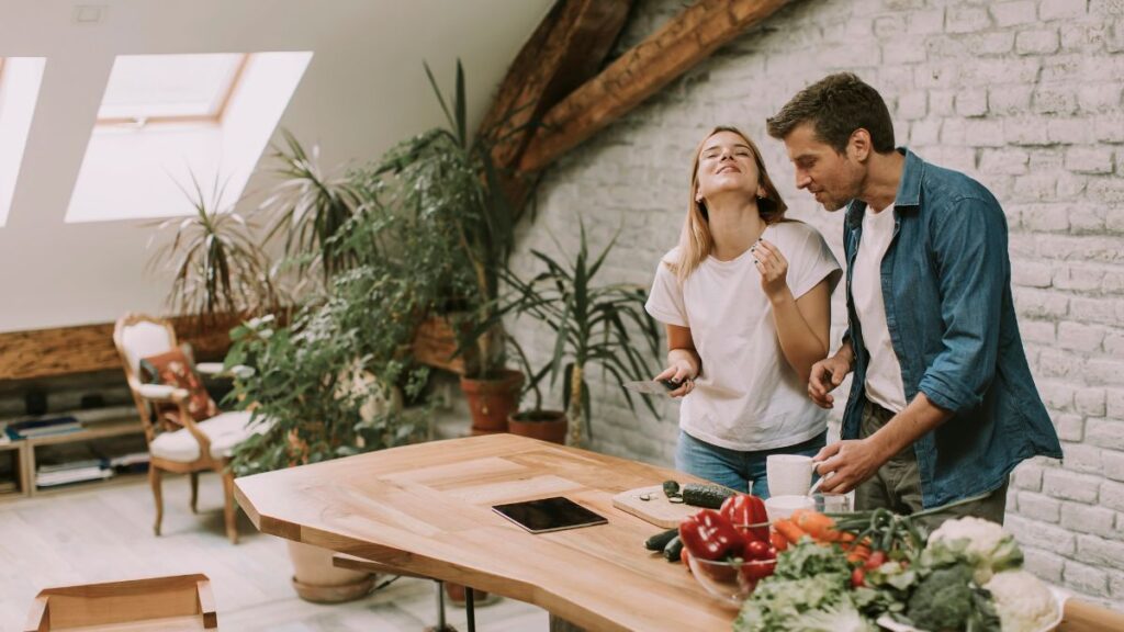 happy couple laughing at kitchen table