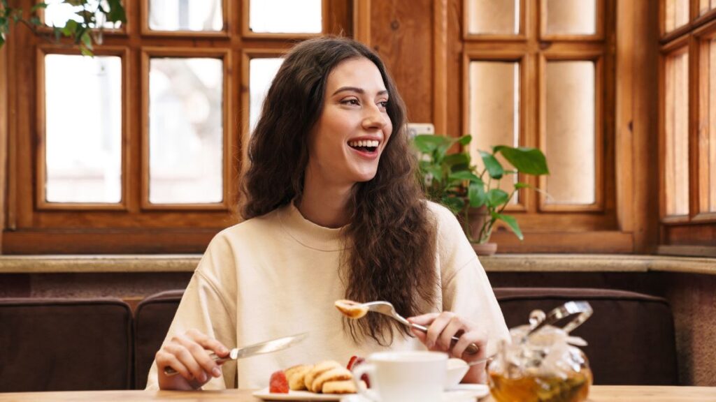 happy woman eating breakfast