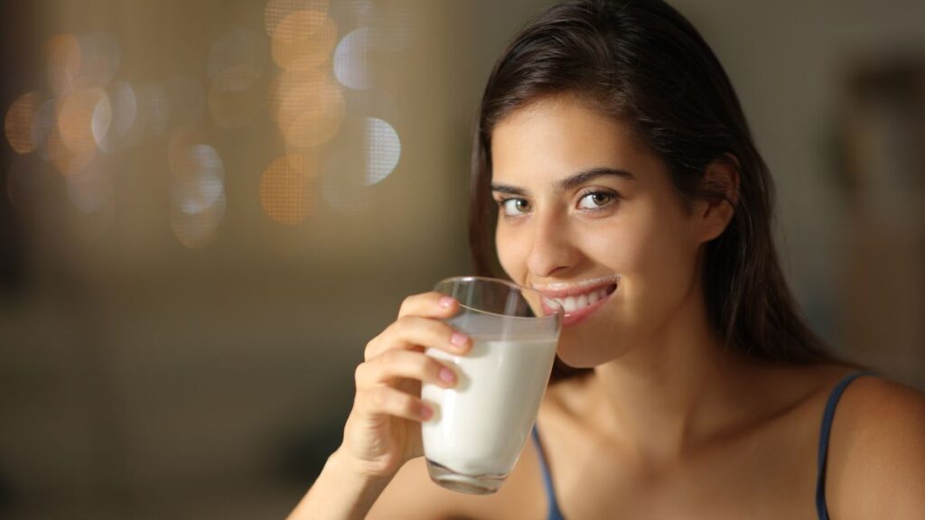 happy woman enjoying a glass of milk