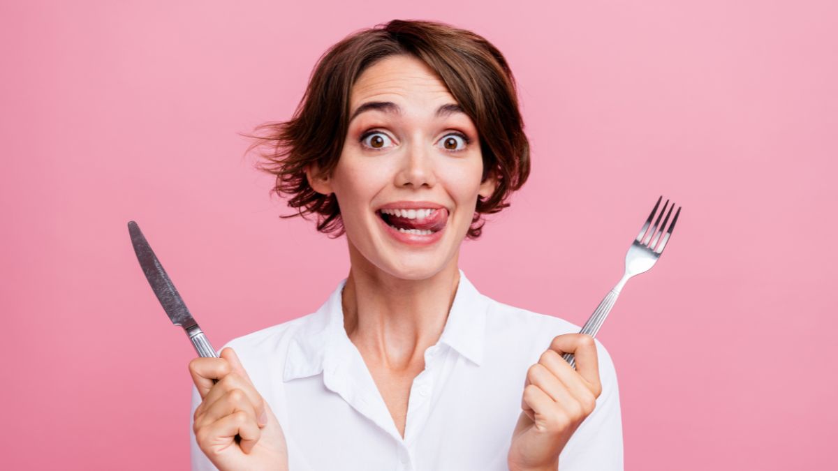 hungry woman with knife, fork and tongue out