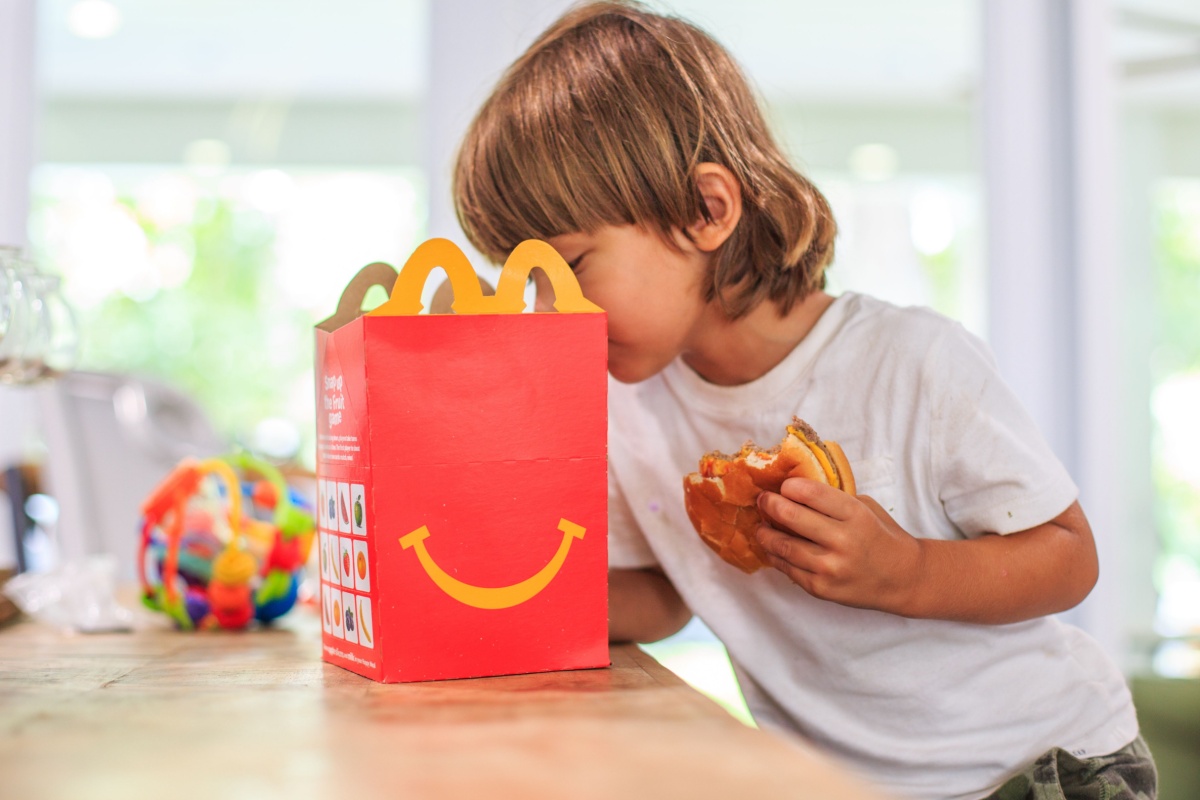 kid looking in Mc. Donald's Happy Meal