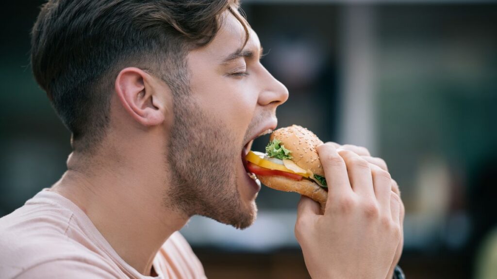 man eating a fast food burger