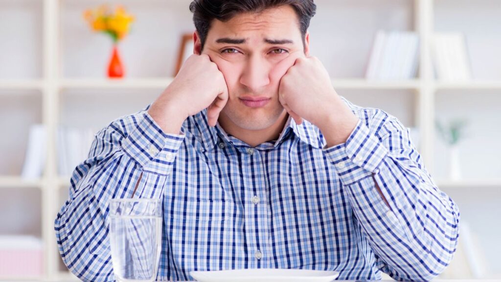 man looking upset waiting for food