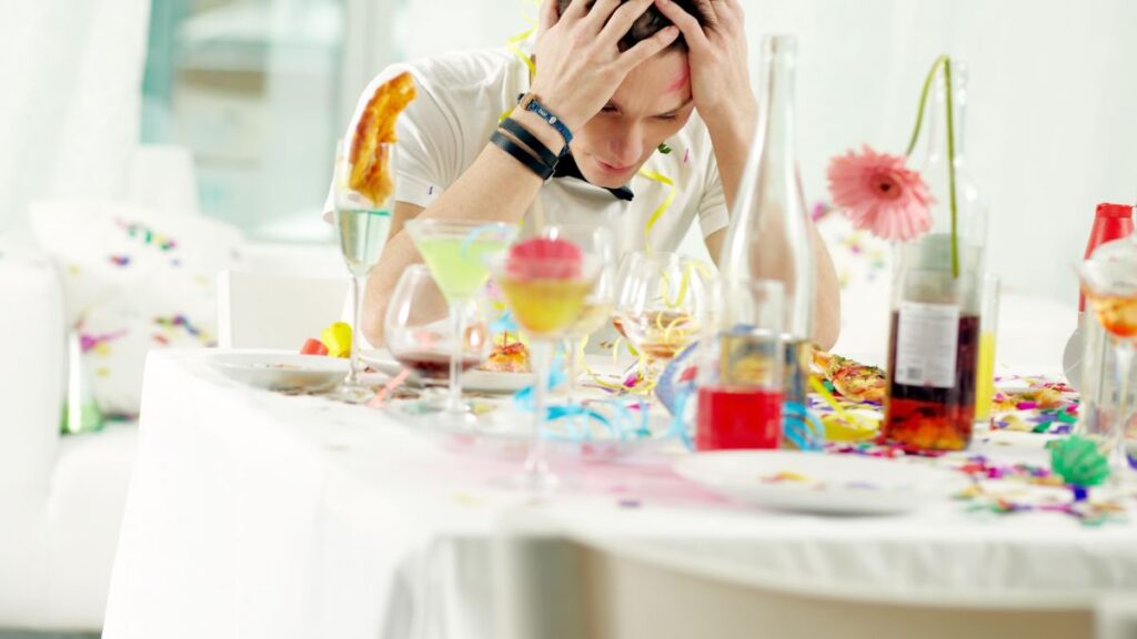 man sitting at messy table