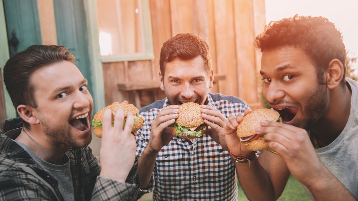 men eating burgers