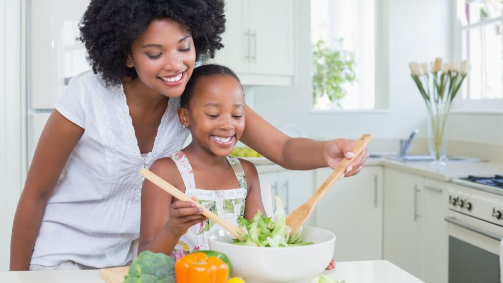 mom and daughter making salad