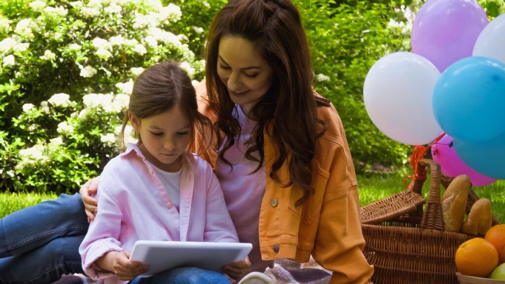 mom and daughter with phone and tablet