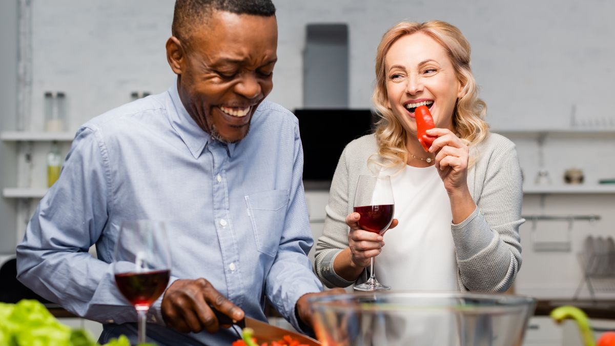 older couple cooking happily