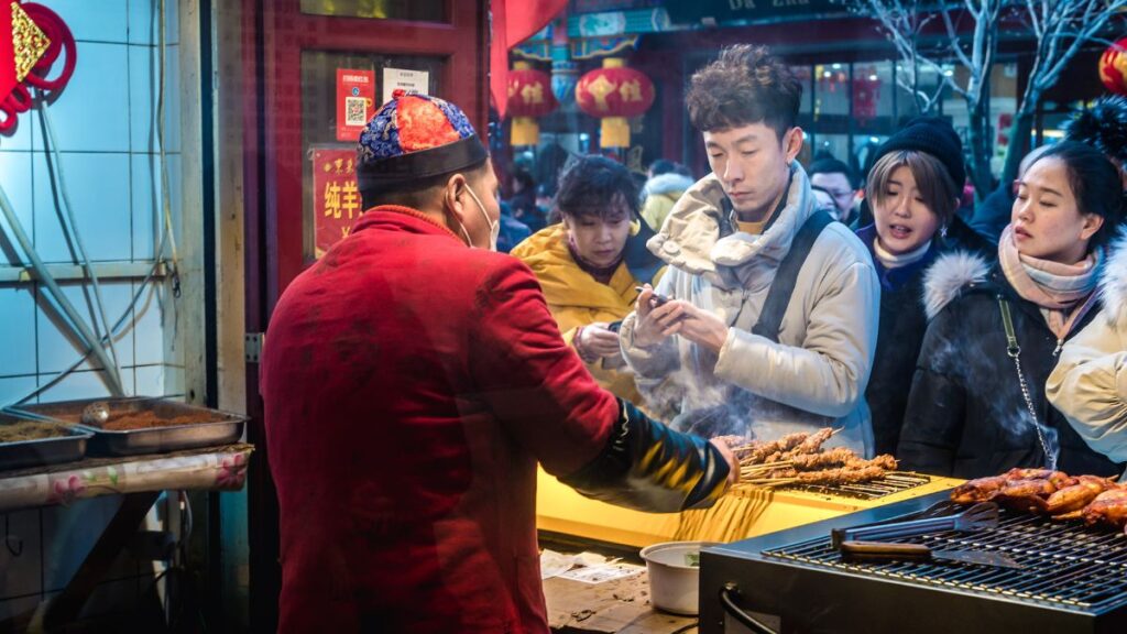 people waiting in line to buy food