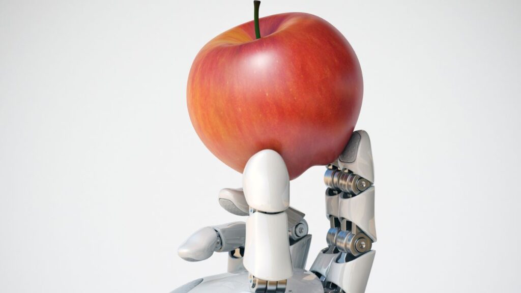 robot hand holding 3d printed apple