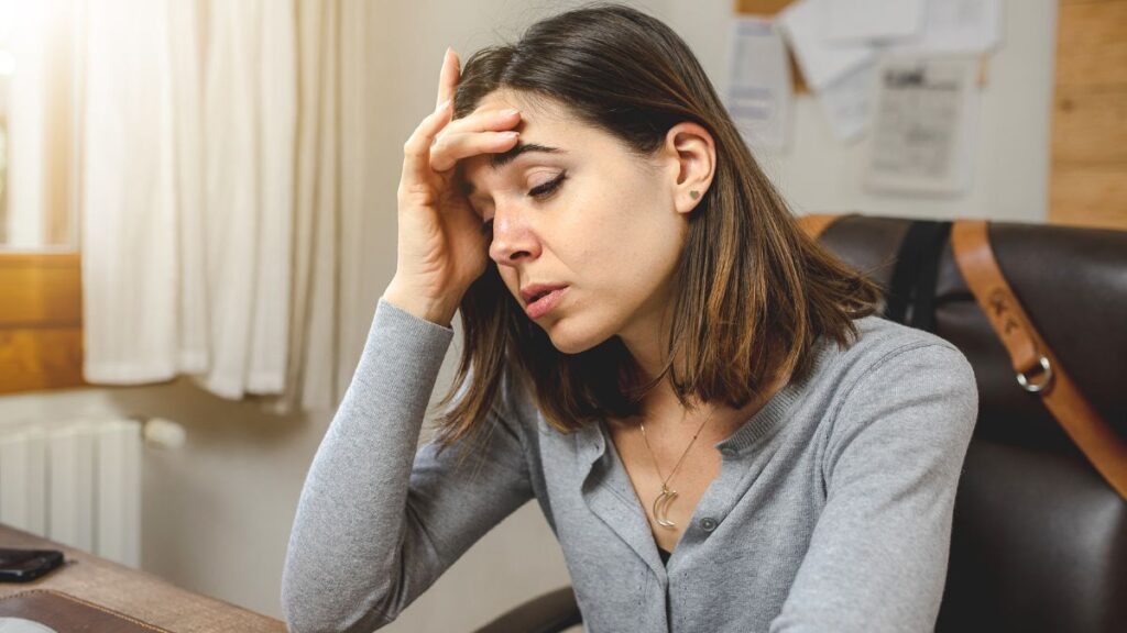 tired woman sitting at desk