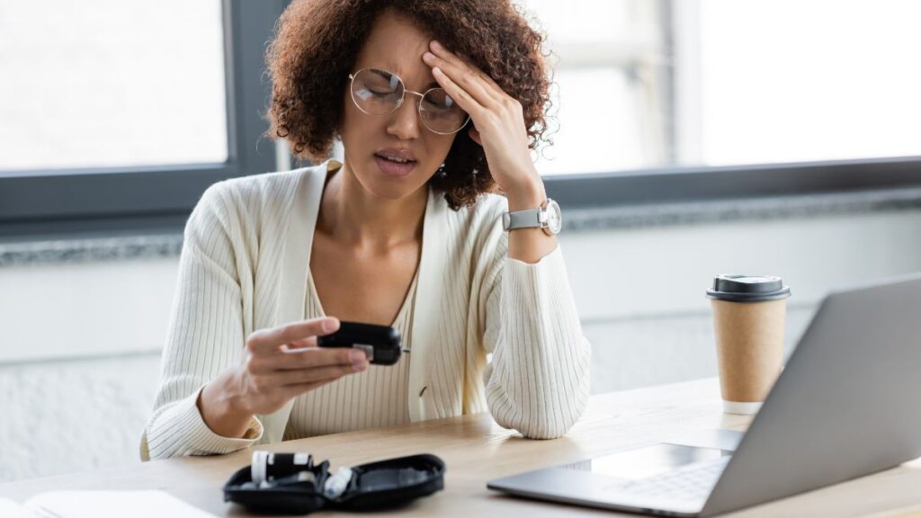 upset woman checking blood sugar