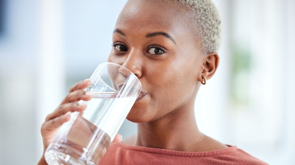 woman drinking a glass of water