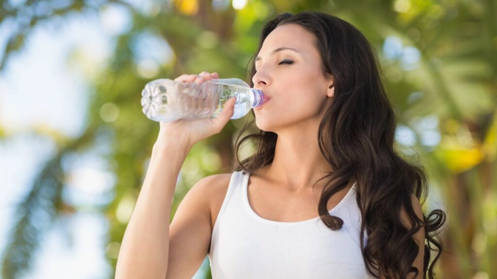 woman drinking bottled water