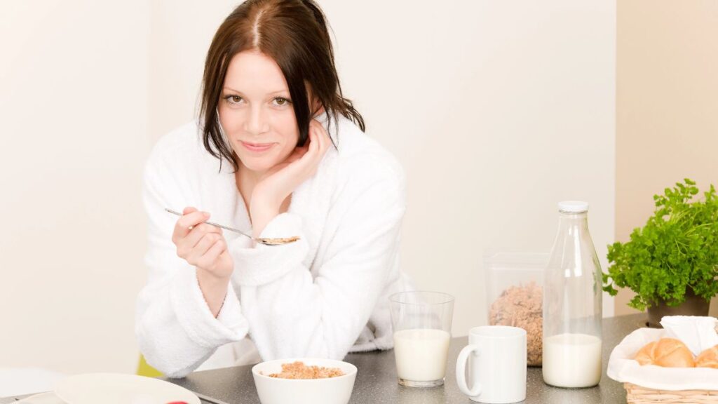 woman eating cereal smiling