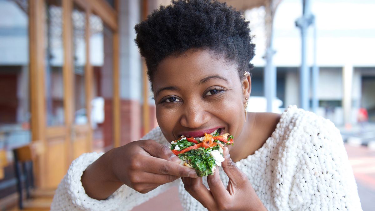 woman eating veggie slice