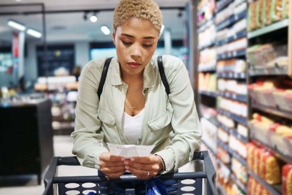 woman grocery shopping looking at a list