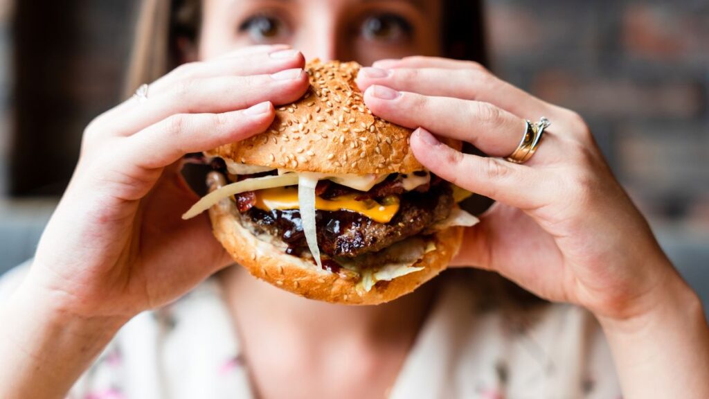 woman holding burger