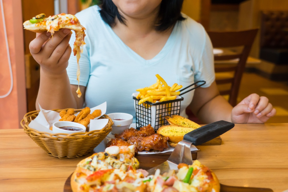 woman holding pizza junk food restaurant