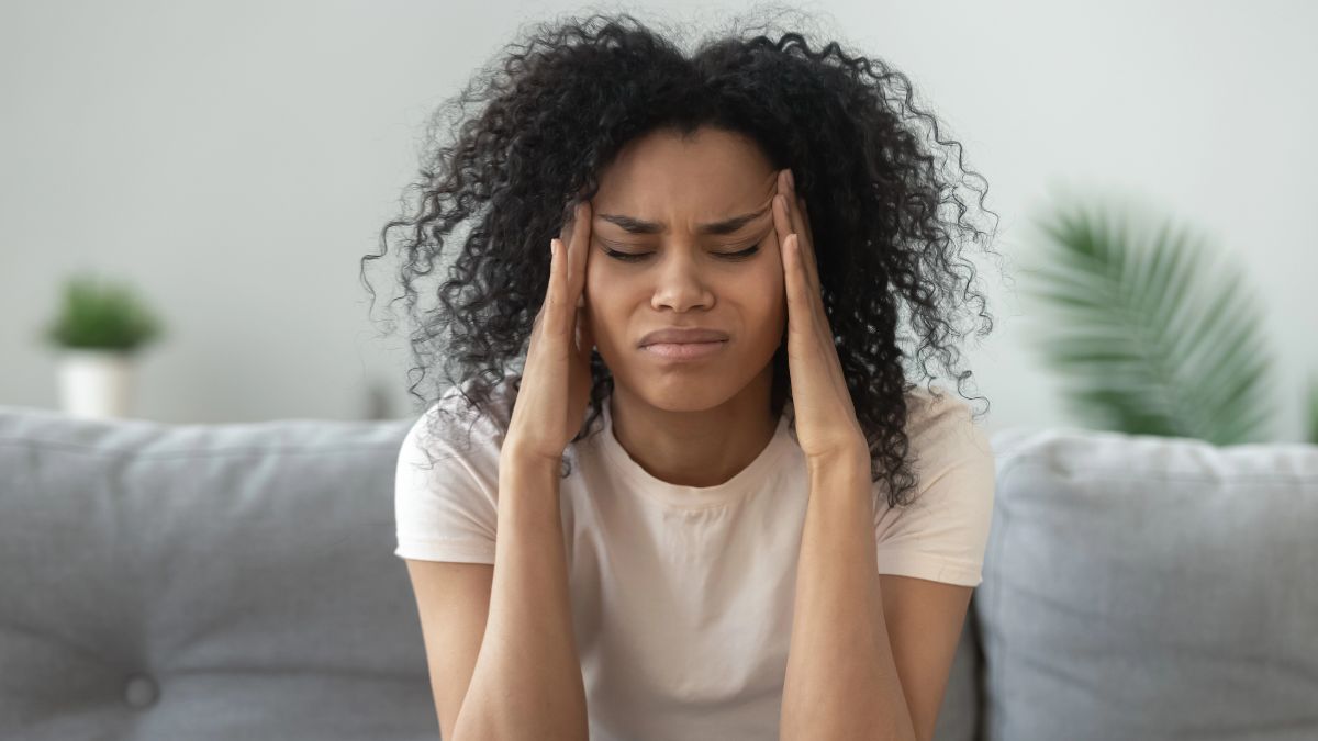 woman in pain holding head