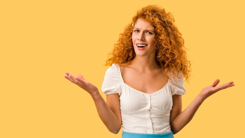 woman looking confused with hands up