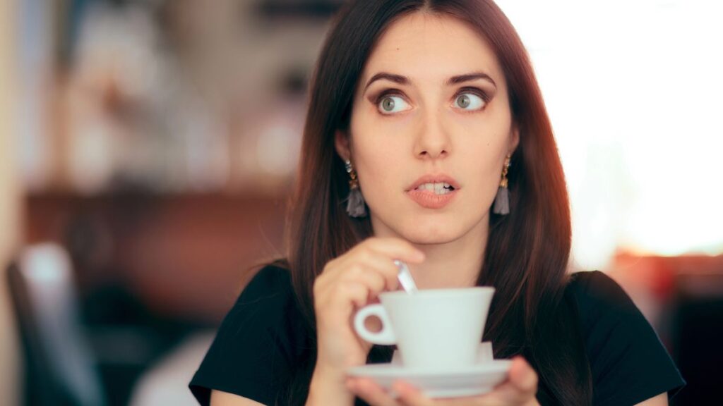 woman looking surprised with coffee