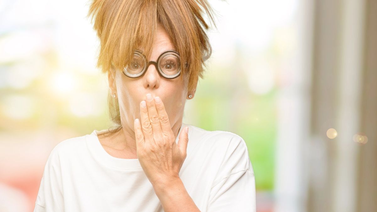 woman looking surprised with hand over mouth