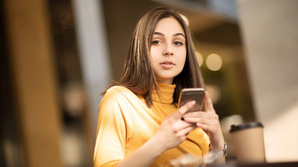 woman on phone at table