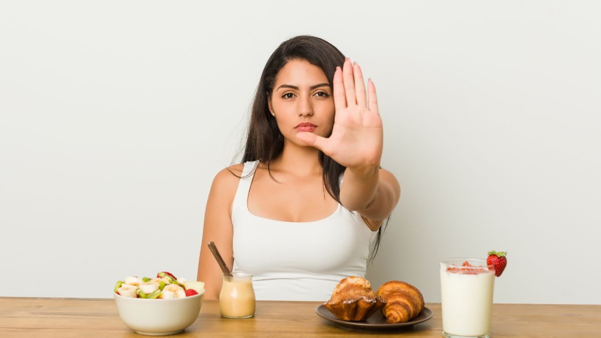 woman showing stop with food choices