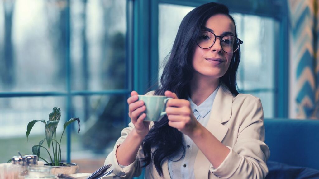 woman sitting with elbows on table with coffee