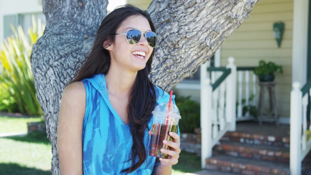 woman smiling with drink