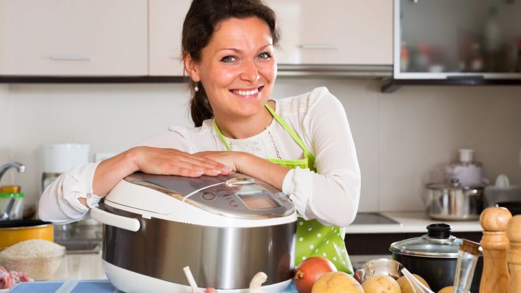 woman smiling with slow cooker