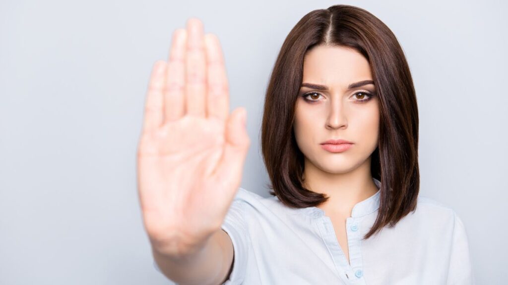 woman with hand up showing stop