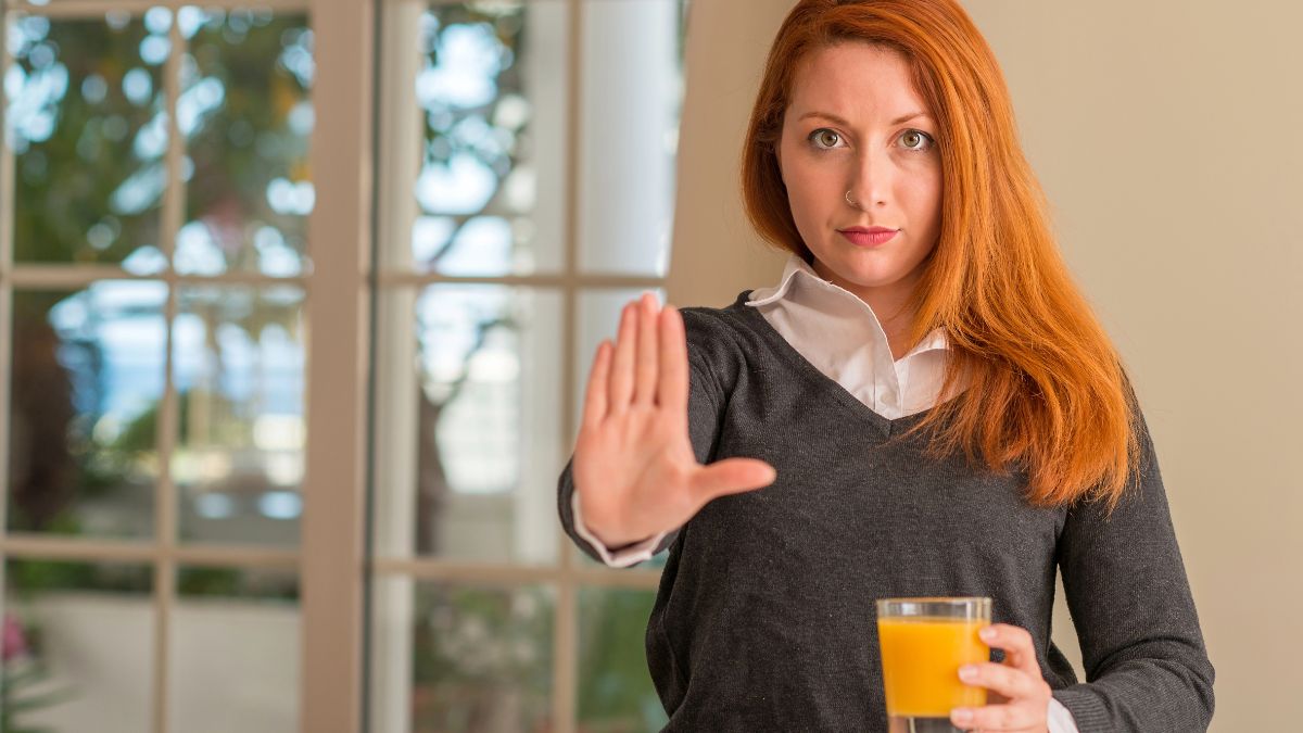 woman with juice showing stop