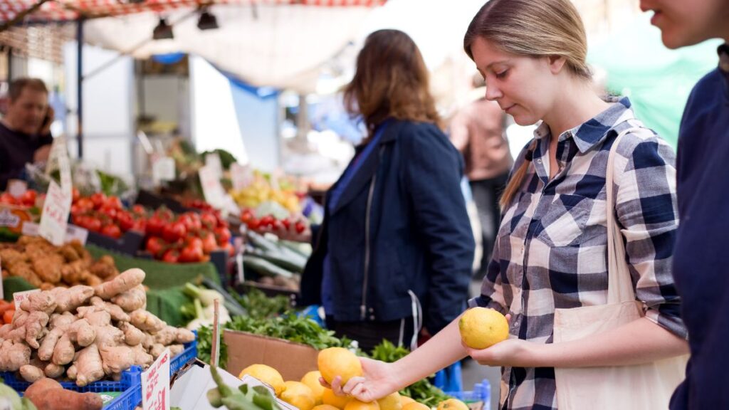 woman with lemon at farmers market