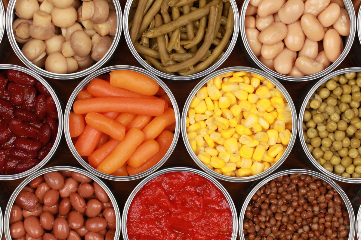 A bunch of opened cans of vegetables