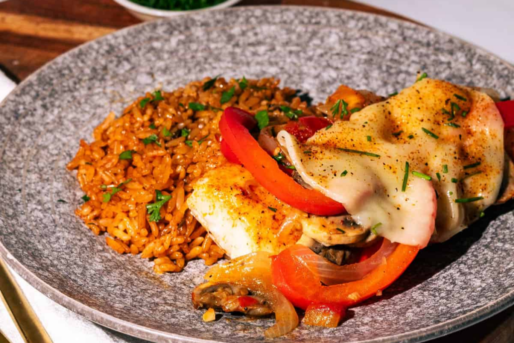 Cheesy Baked White Fish With Onions, Peppers, And Mushrooms 