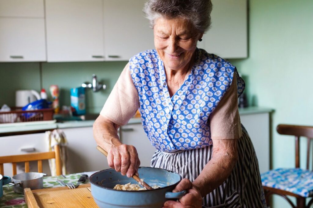 Older lady cooking in her apron