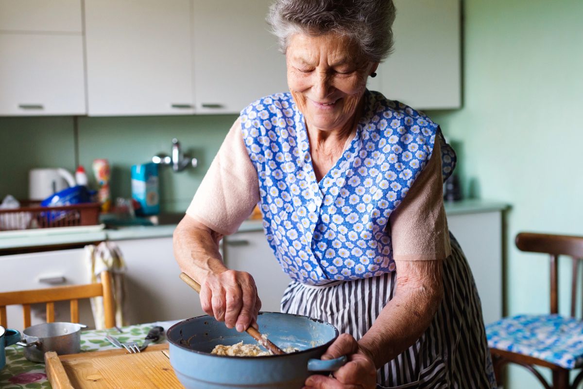 Older lady cooking in her apron